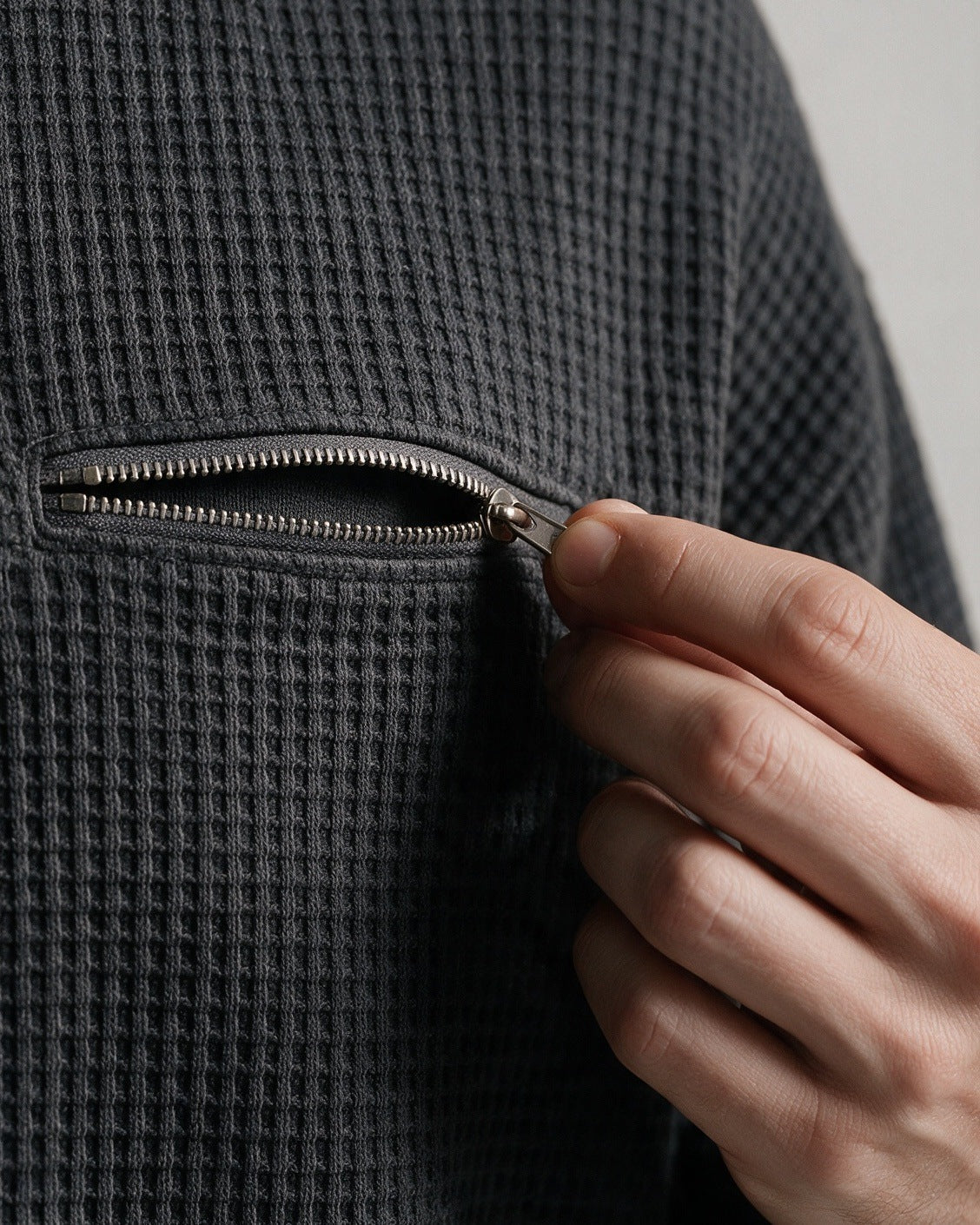 Selby chest zip pocket on the waffle knit, close-up