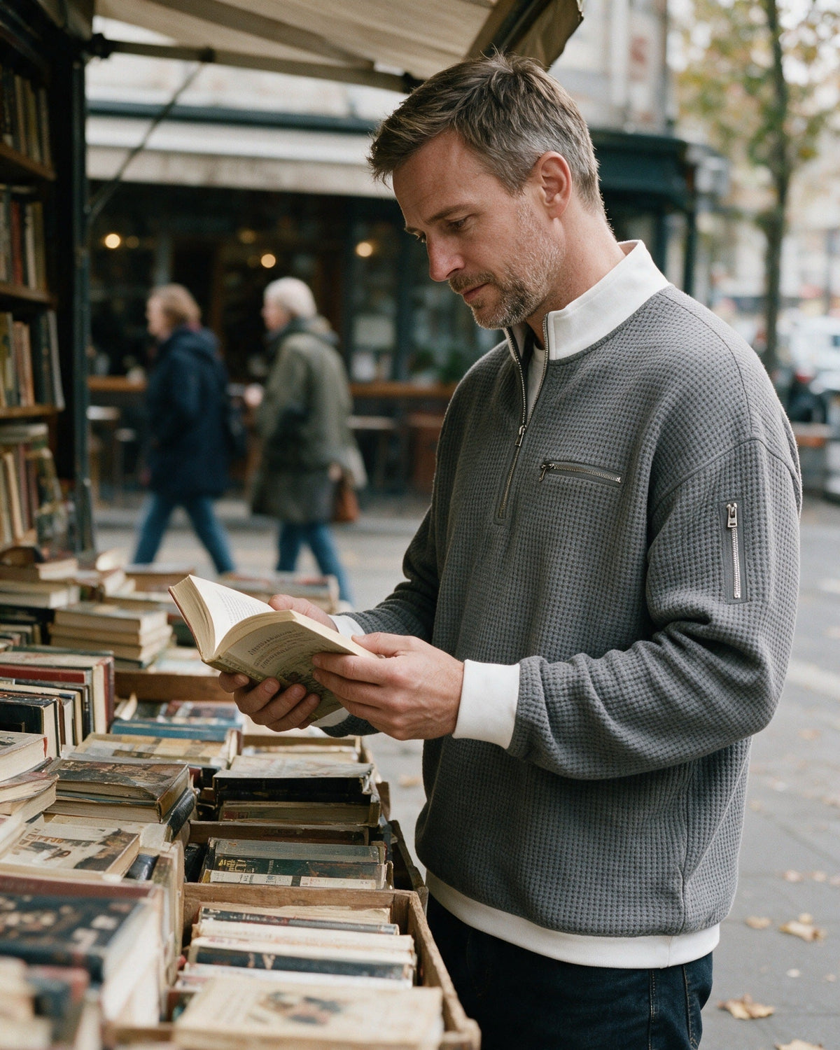 Selby half-zip pullover in Grey, worn at a street book stall