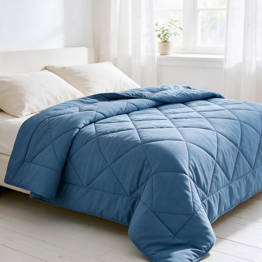 Bedroom with a blue all-season duvet on a made bed