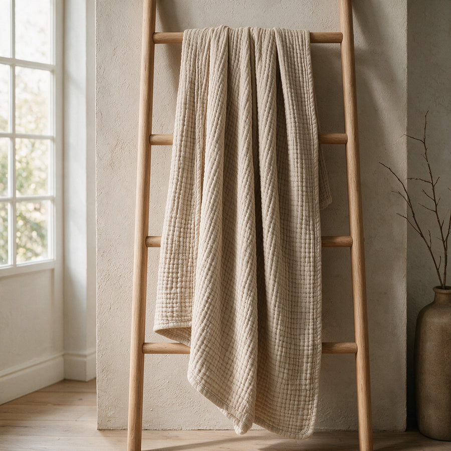 Muslin blanket hanging from a wooden ladder