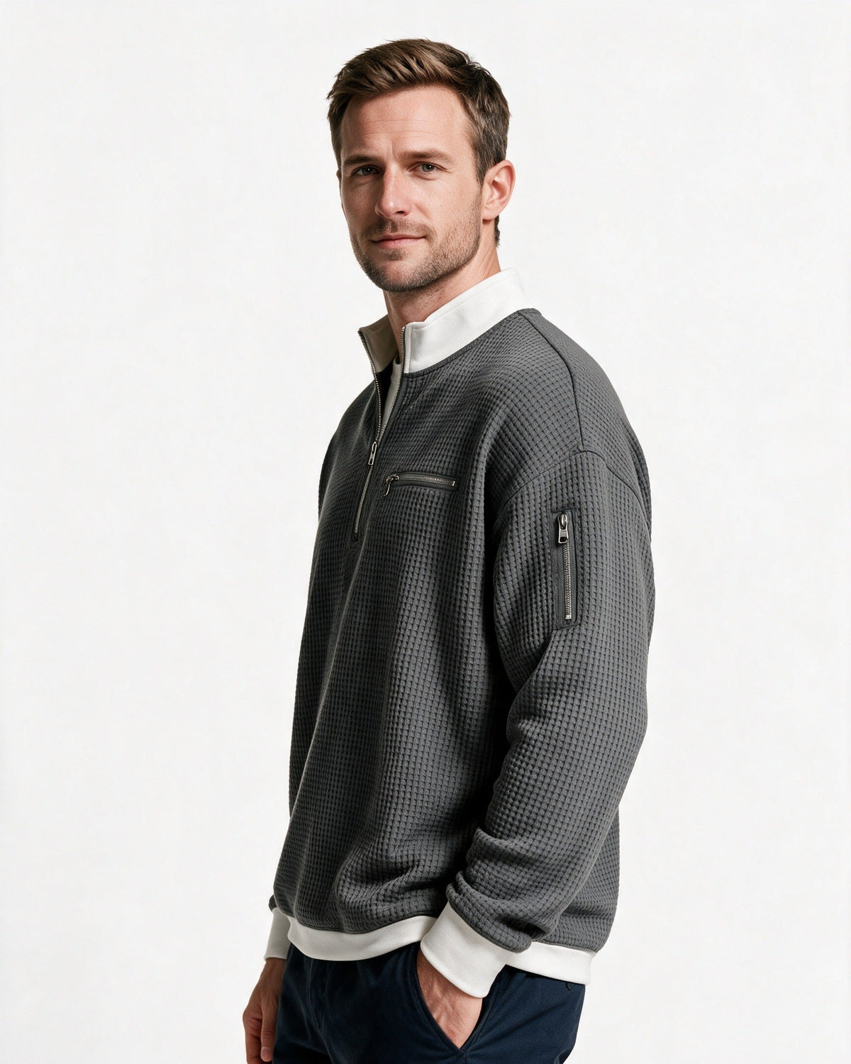 Selby half-zip pullover in Charcoal, three-quarter view with the sleeve zip pocket