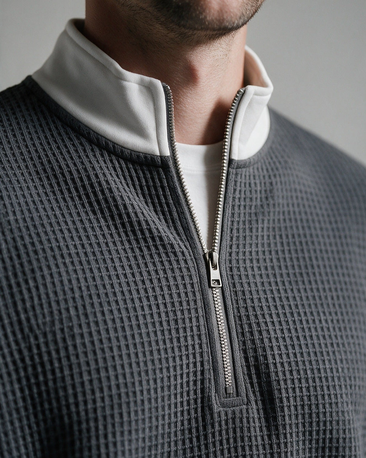Selby stand-up collar with white contrast panel and metal half-zip, close-up