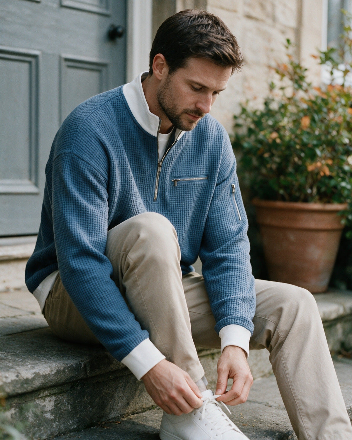 Selby half-zip pullover in Blue, worn on a front step
